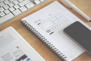 A Notebook, and a Smartphone used for outsourcing web design