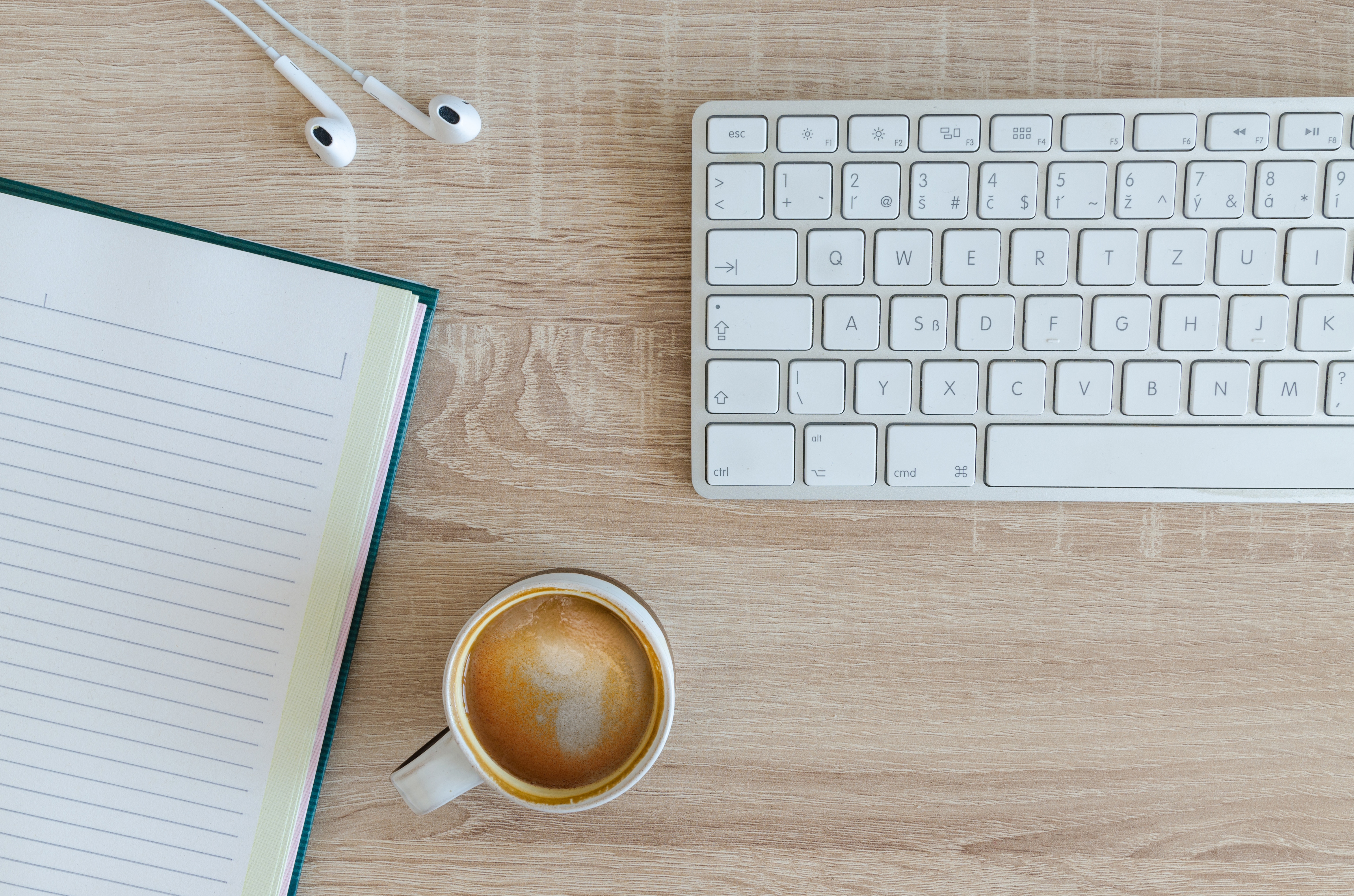 a table with laptop and coffee above it used for blog writing