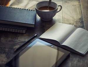 Books, a tablet, and a cup of coffee