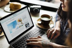 woman reading an article on how to write different types of blogs