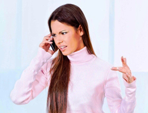 Handling rude customers characterized by female in pale pink turtle neck sweaters complaining over the phone