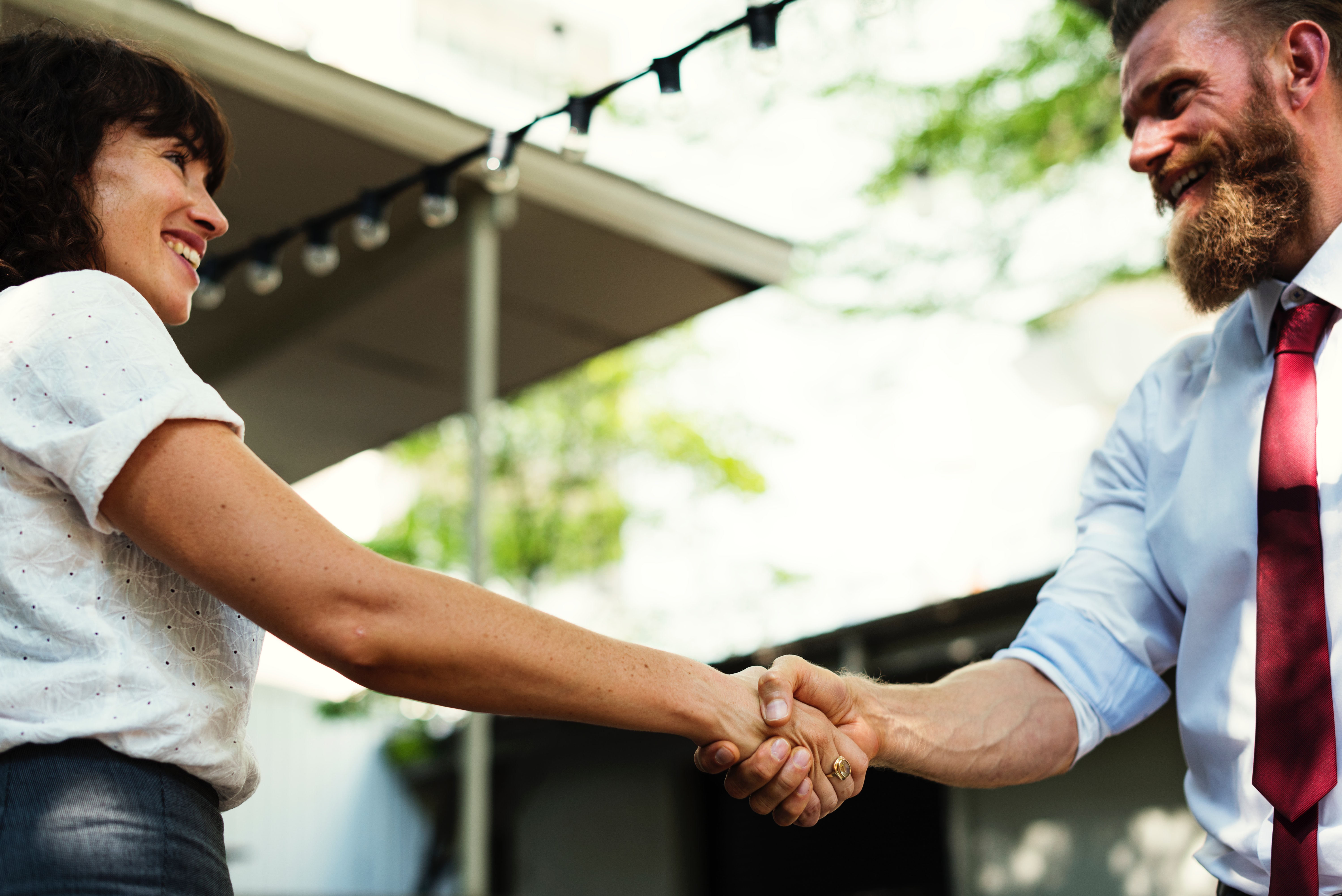 Virtual Assistant says thank you by shaking hands of client