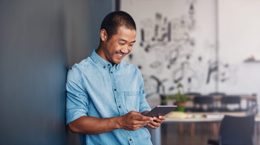 Filipino dad looking at his tablet to signify his funny antics