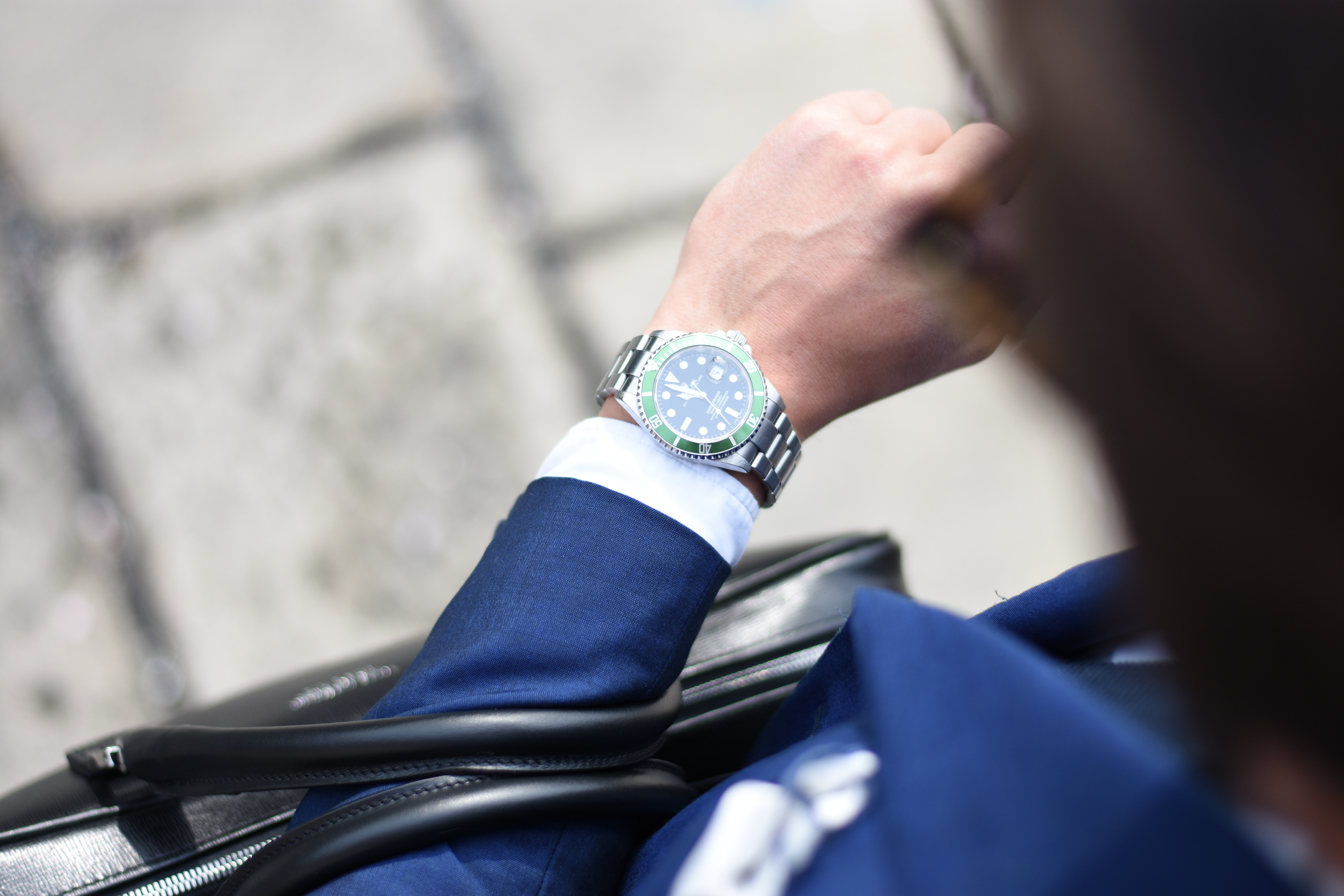 effective time management - a man in blue suit looking in a wrist watch