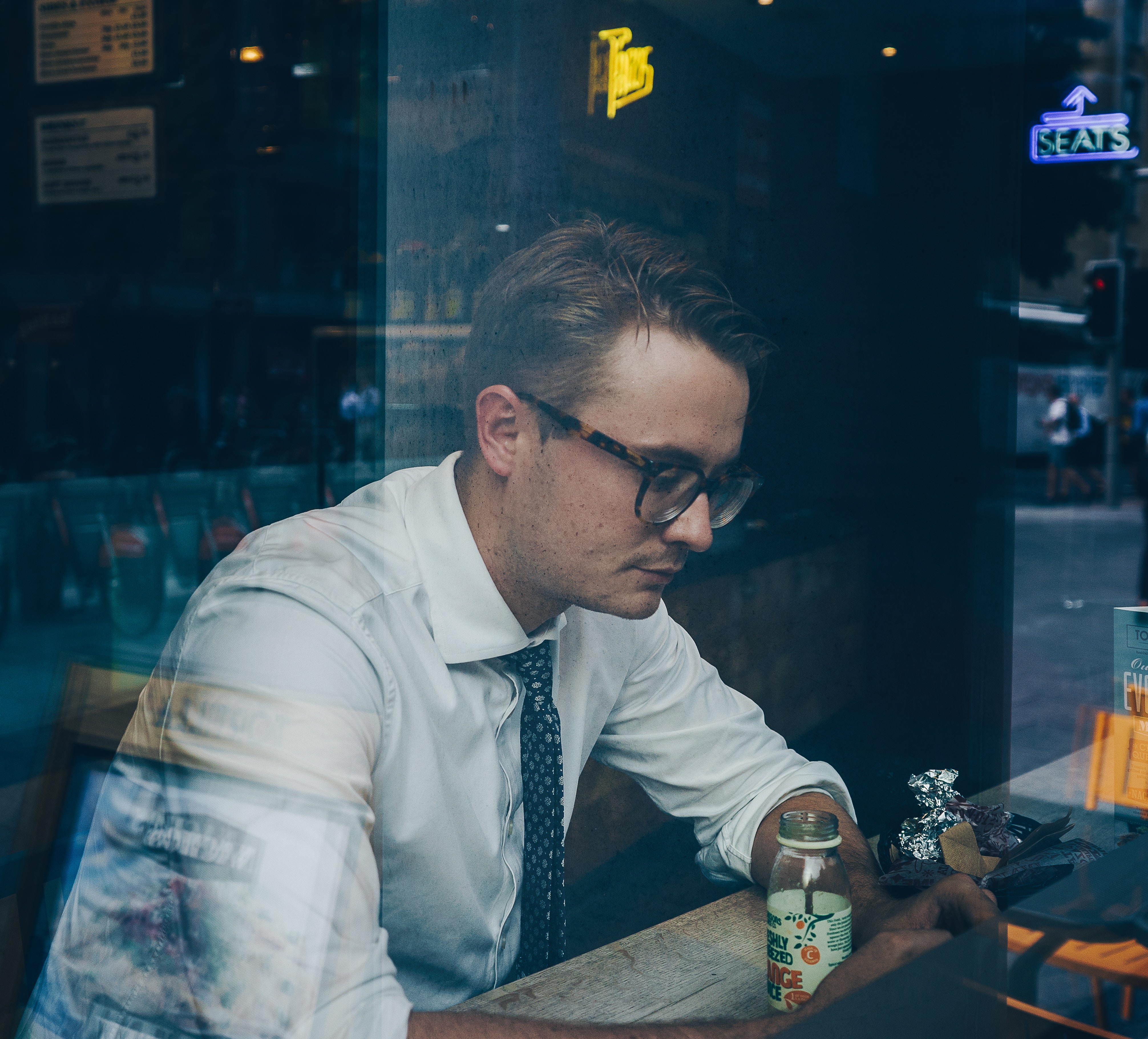 a man with glasses figuring out how to save up with money saving tips for employees