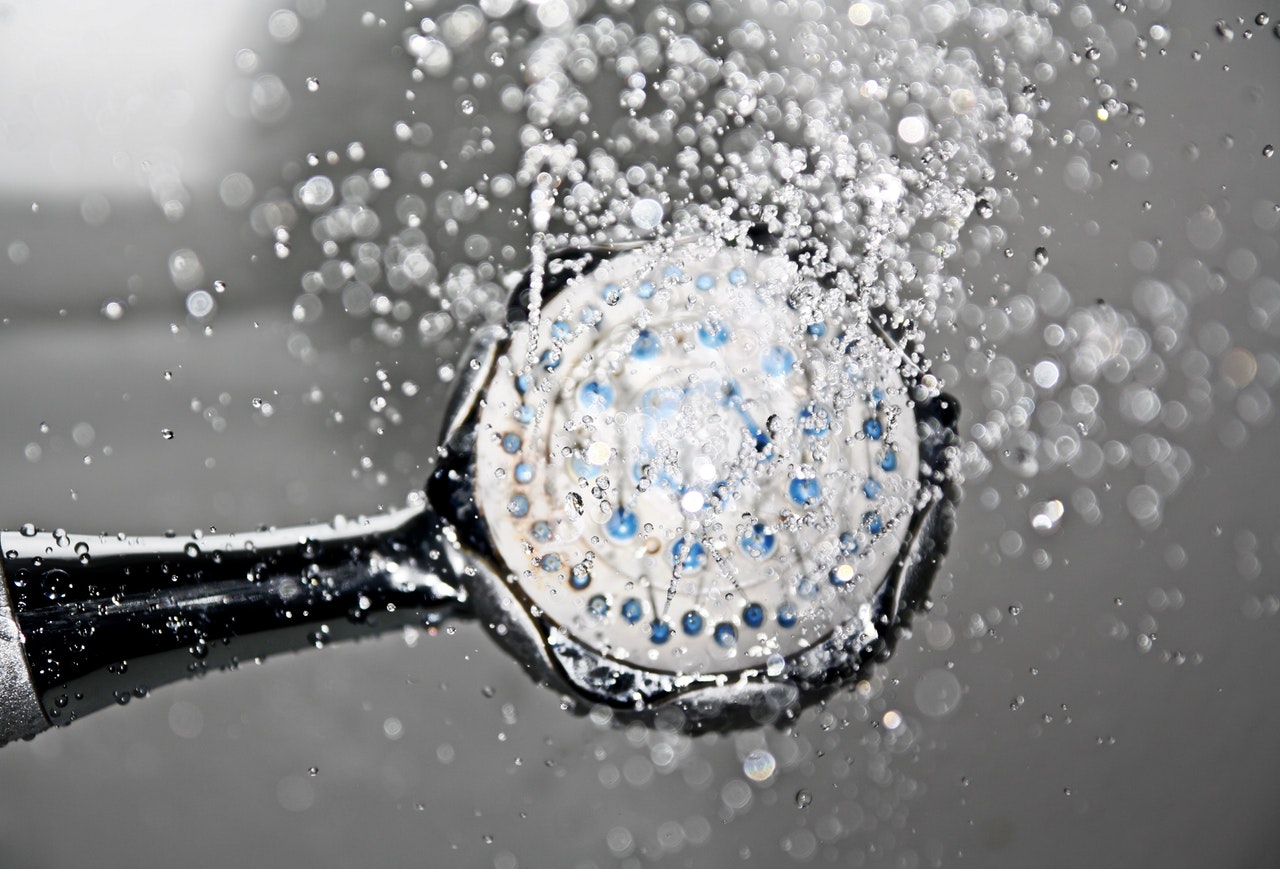 tag-init survival tips shower head with water coming out from it