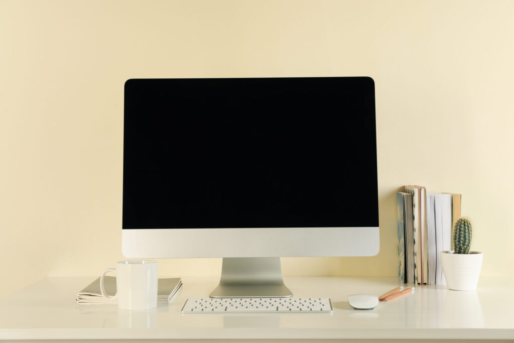 Must-have desktop with books and a cup to increase employee productivity