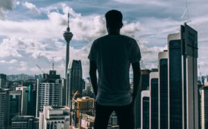 man looking at buildings - millennial employees