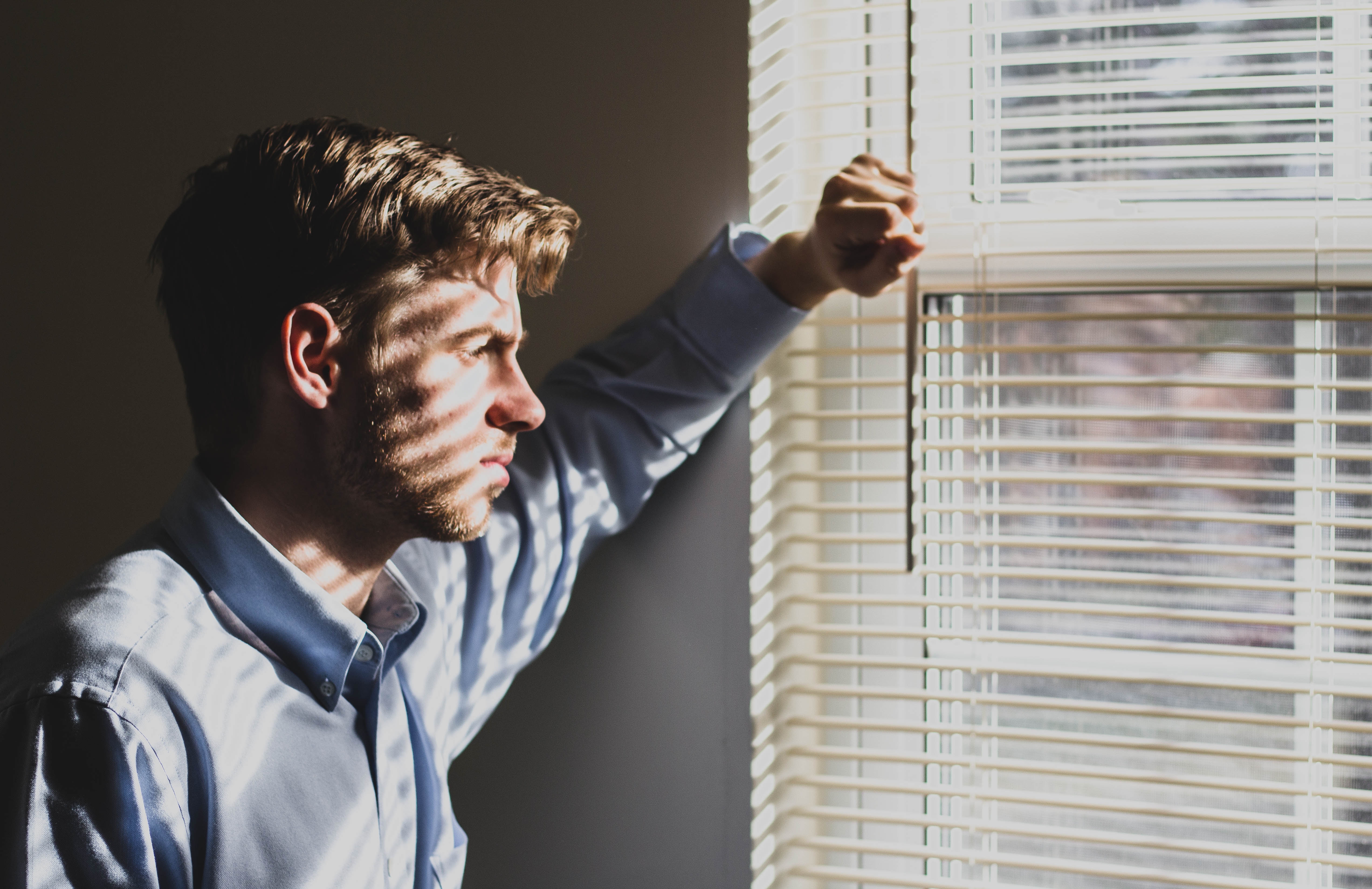 a man looking outside the window - a working student