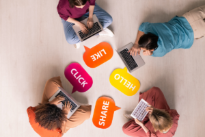 a group of people using their laptopss to