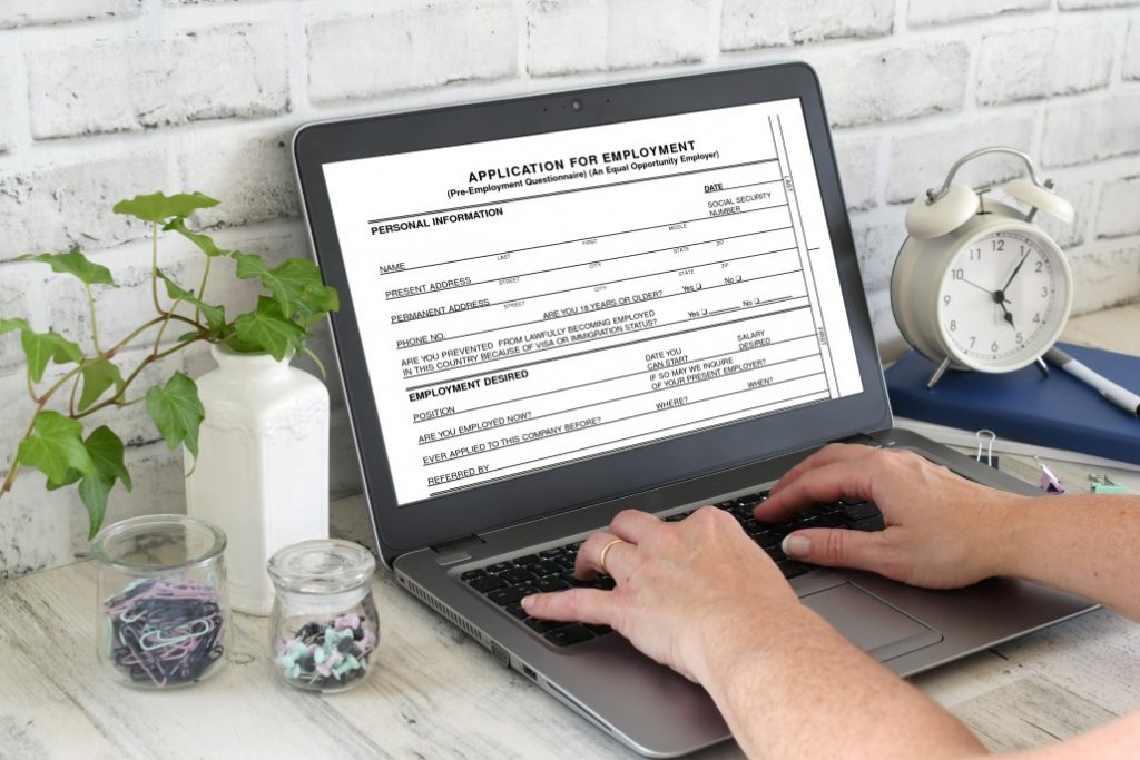Job seeker filling out application form as a part of the career planning process.