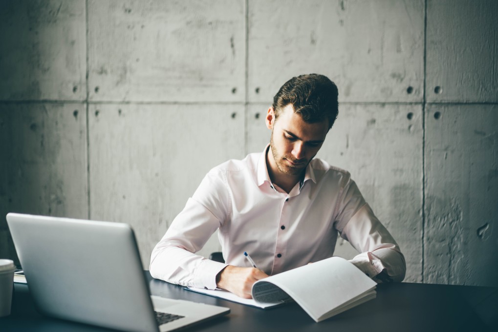 Man writes notes and steps of career planning process for a better career.
