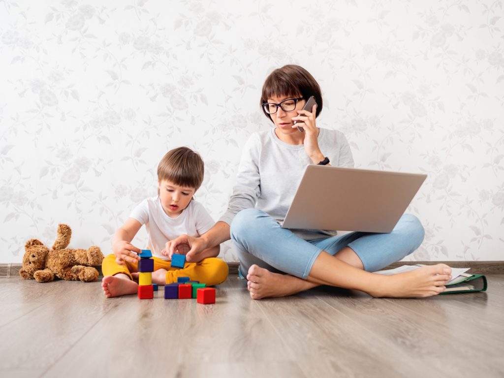 mom working from home playing with her child