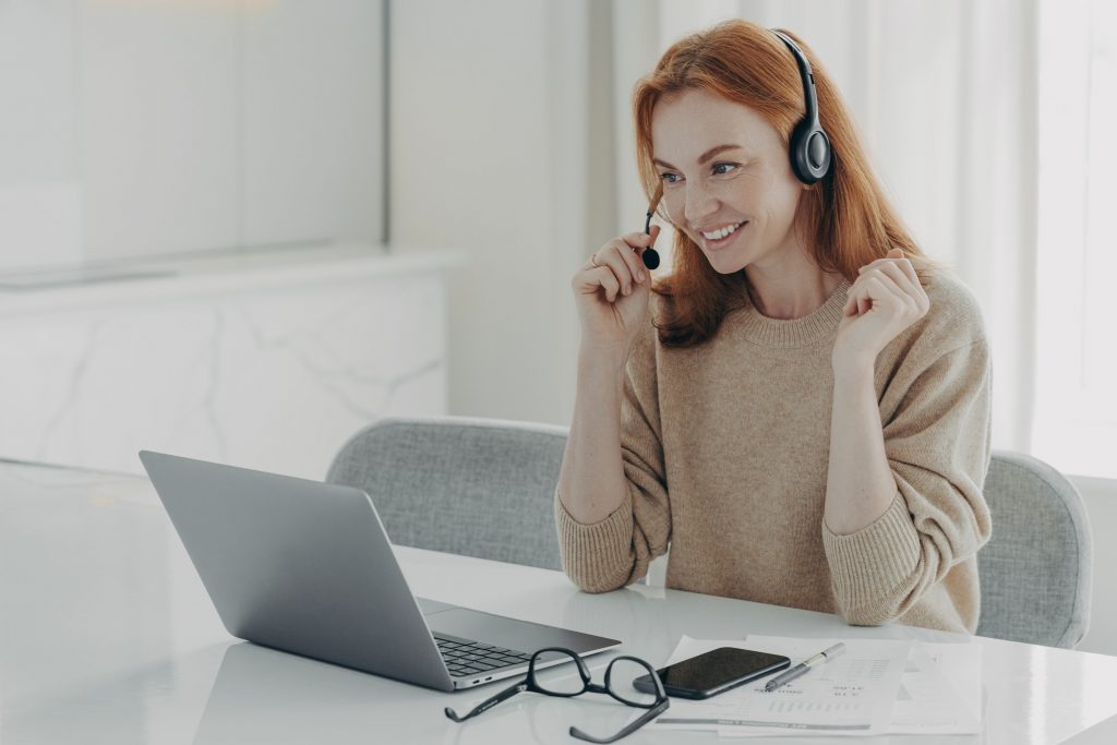 female virtual assistant headset communicating with business owner