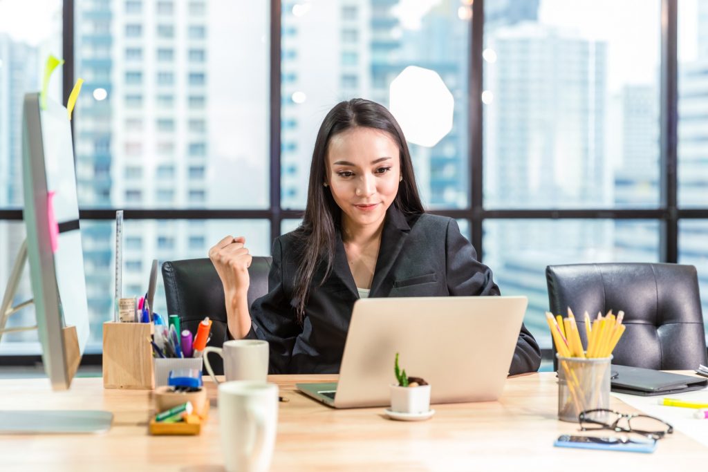 business employee motivating herself as she finishes work tasks