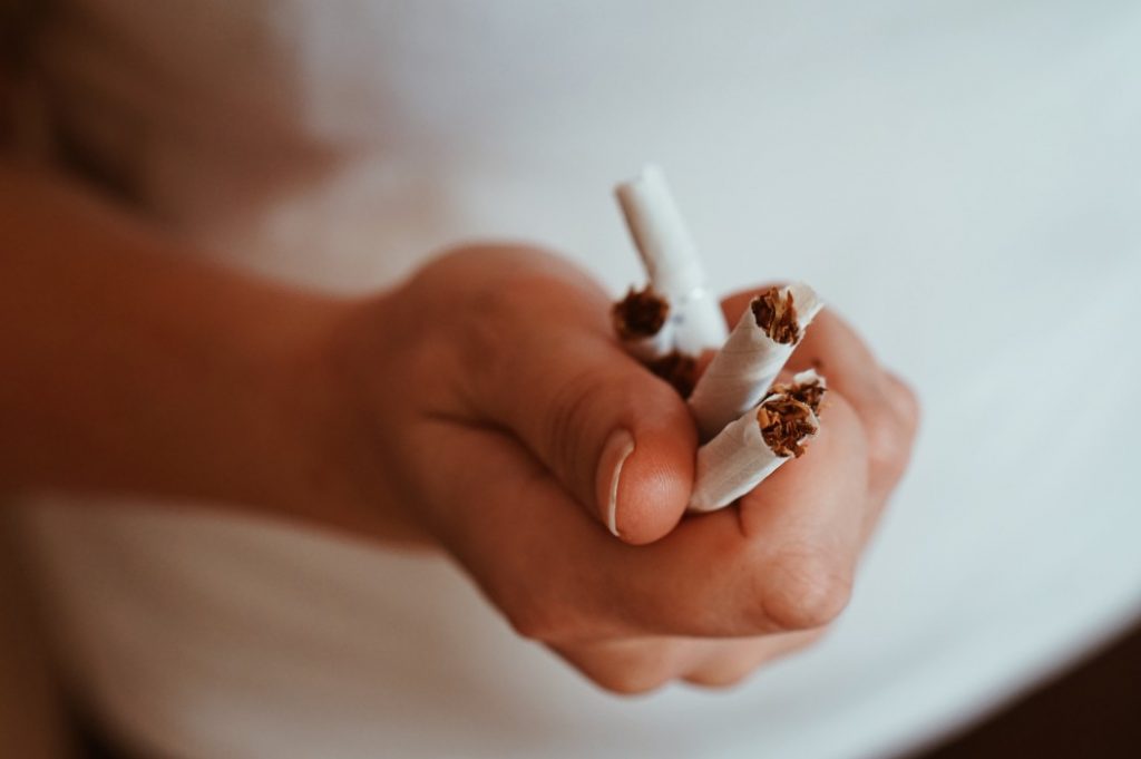 crumpled cigarettes in one's hand