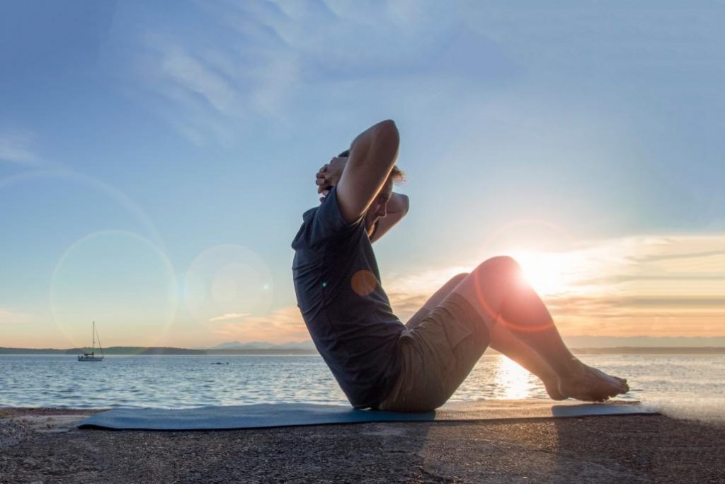picture of man exercising by the sea