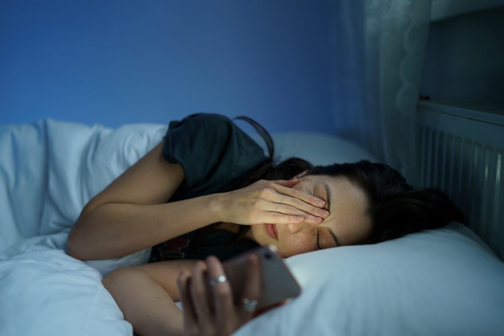 tired woman having trouble with sleeping because of work stress