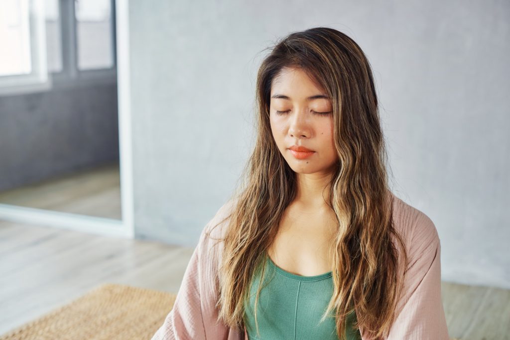 young woman sitting and meditating