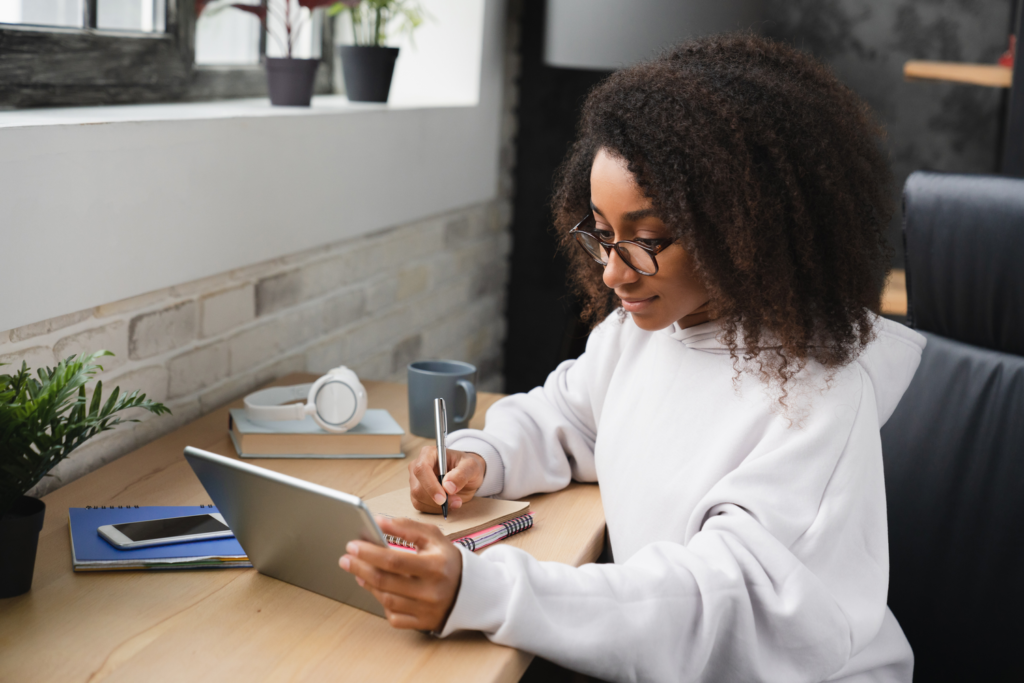 a woman taking note of the importance of social media marketing in business