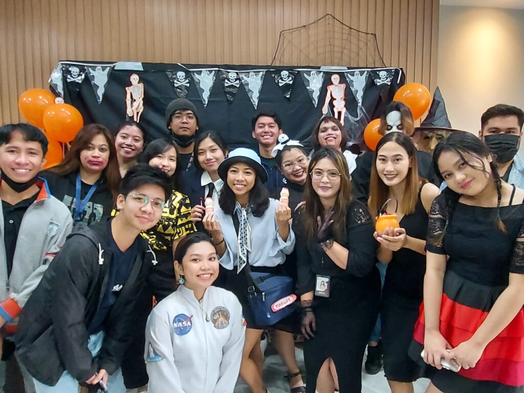 Employees posing with the company’s President, Ms. Celina Mercado (Middle)