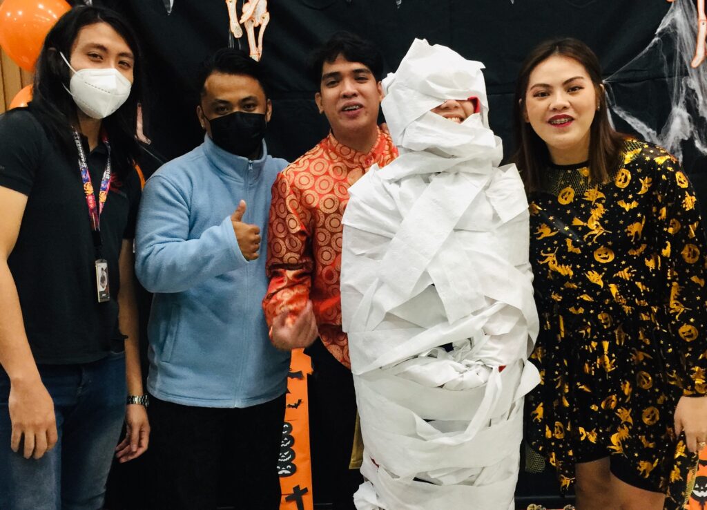 Flexi Team with their teammate wrapped as their mummy.