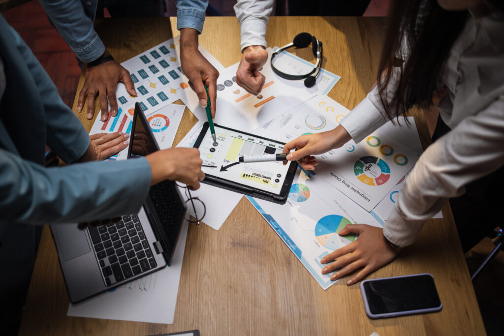 A team of experts analyzing charts and graphs