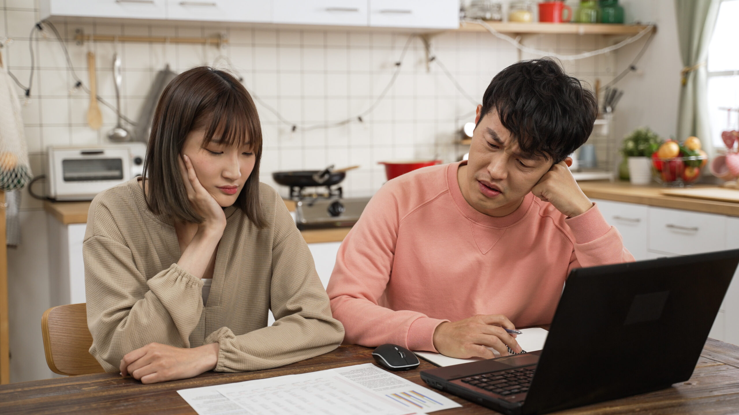 unhappy married couple calculating budget