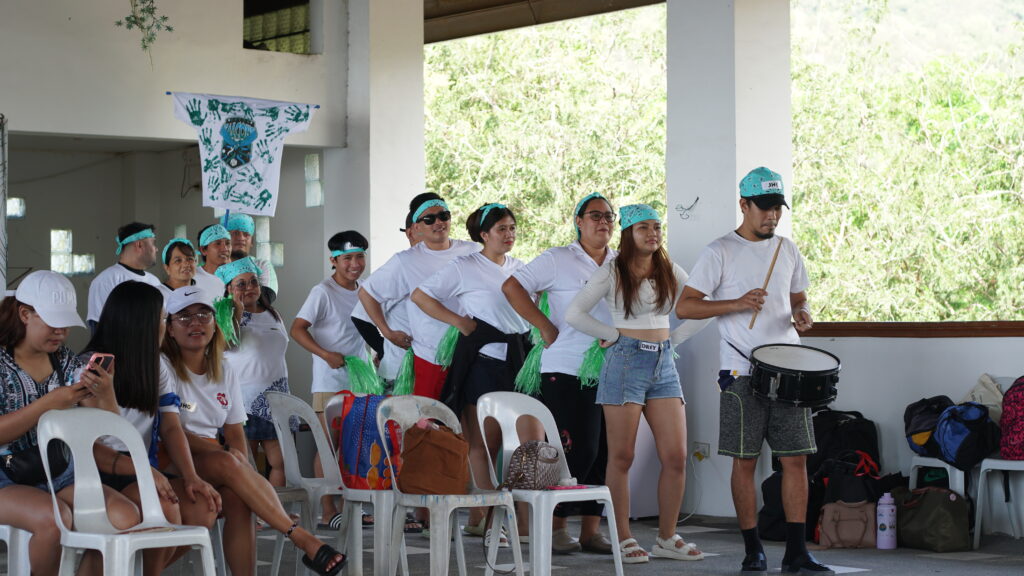 Green Falcons team parading their flag while doing their cheering number