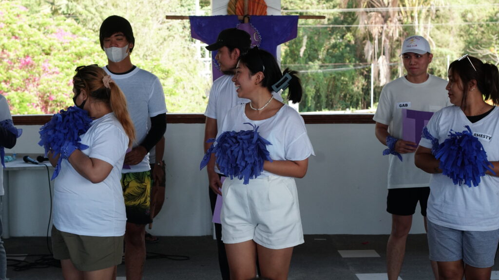 Purple Harpies team doing their cheering number while parading their flag