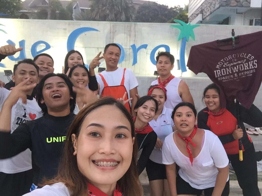Red Phoenix posing with a Blue Coral Beach Resort employee for the Treasure Group Picture Hunt