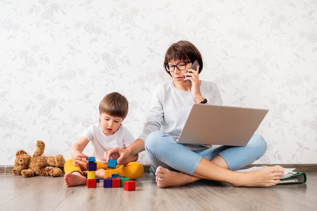 mom working from home playing with her child