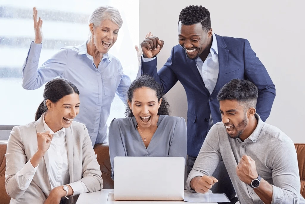 colleagues celebrating the financial success of their coworker